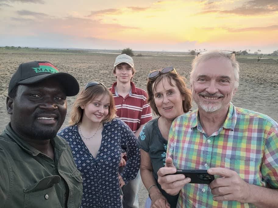 William with travellers at sunset in Malawi
